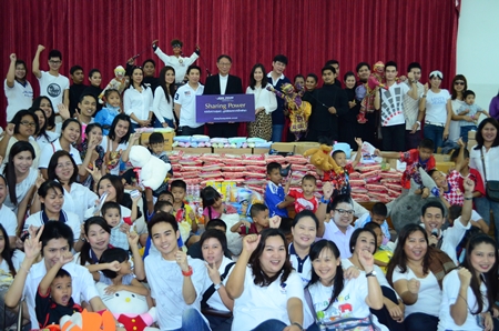 Fr. Michael Weera Phangrak (center), executive director of the orphanage, accepts donations from Piya Rattanaburee, manager of customers relations, and Sukhrudee Pongpanwattana, director of creative and corporation communications, with the committee from King Power Co. Ltd., and the performers, care givers and children.